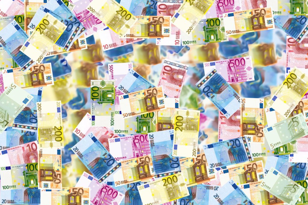Euro bills spread out on a table.