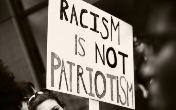 Demonstration sign stating, Racism is not Patriotism. Photo Credits: Javier Robles.